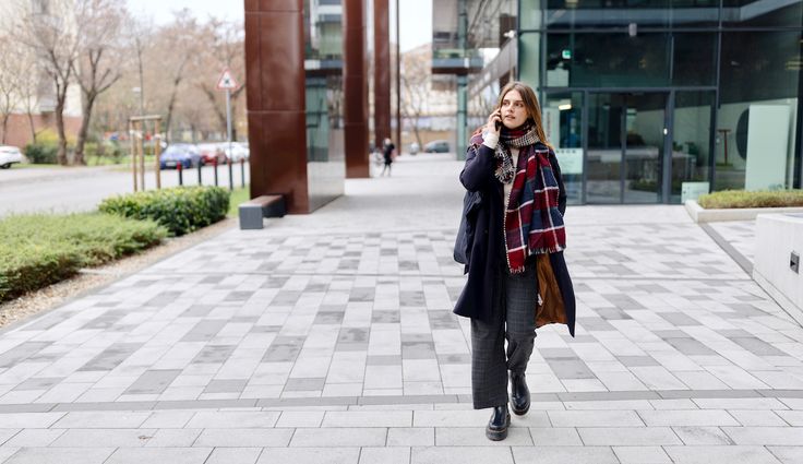 Smiling businesswoman talking on the phone in the street