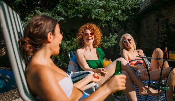 Girlfriends sunbathing in the backyard