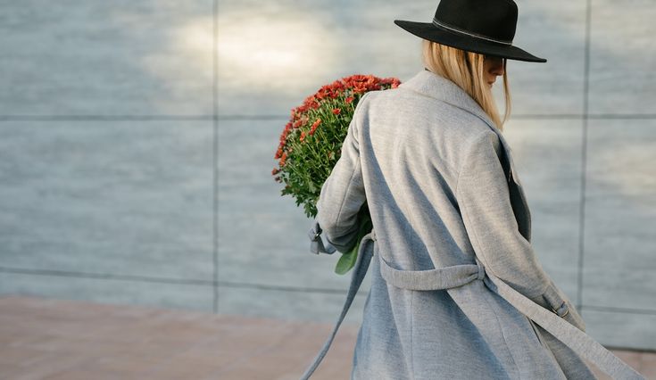 Stylish Woman Walking With A Bouquette Of Flowers